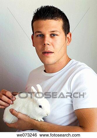 Young man with rabbit View Large Photo Image Stock Photograph - Young man with rabbit. Fotosearch