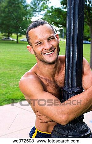 Young shirtless Hispanic man standing in a fight stance on the grass at a park View Large Photo Image Stock Photo - Young shirtless Hispanic man standing in a fight stance on the grass at a park. Fotosearch