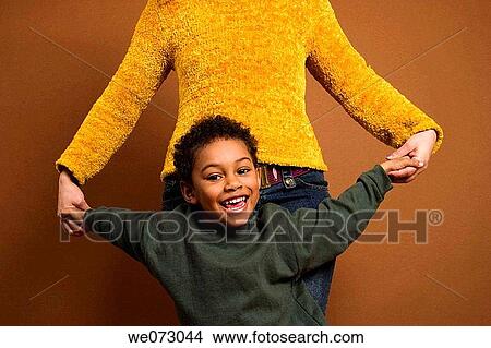 Young Spanish boy being held by his mother. View Large Photo Image Picture - Young Spanish boy being held by his mother.. Fotosearch