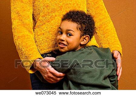 Young Spanish boy being held by his mother. View Large Photo Image Stock Photography - Young Spanish boy being held by his mother.. Fotosearch