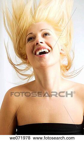 Young woman flips here hair back in studio portrait in Los Angeles, California, USA View Large Photo Image Stock Photo - Young woman flips here hair back in studio portrait in Los Angeles, California, USA. Fotosearch