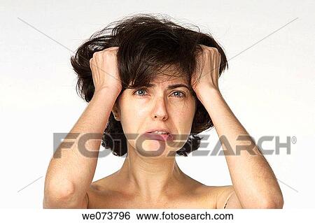 Young woman in her 30s desperately grabbing her hair View Large Photo Image Stock Photograph - Young woman in her 30s desperately grabbing her hair. Fotosearch