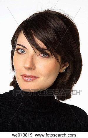 Young woman in her 30s posing in a studio setting View Large Photo Image Stock Photo - Young woman in her 30s posing in a studio setting. Fotosearch