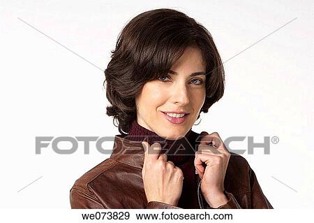 Young woman in her 30s posing in a studio setting View Large Photo Image Stock Photo - Young woman in her 30s posing in a studio setting. Fotosearch