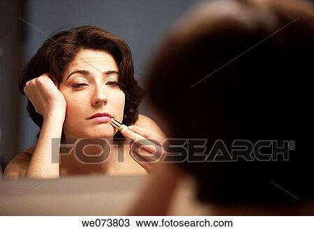 Young woman in her 30s tired falling asleep while trying to apply herself lipstick View Large Photo Image Stock Image - Young woman in her 30s tired falling asleep while trying to apply herself lipstick. Fotosearch