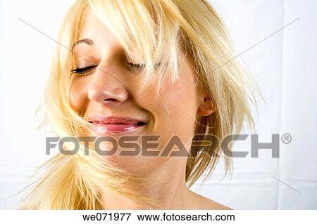 Young woman model tosses here hair from side to side in studio portrait, Los Angeles, California, USA. View Large Photo Image Stock Photo - Young woman model tosses here hair from side to side in studio portrait, Los Angeles, California, USA.. Fotosearch