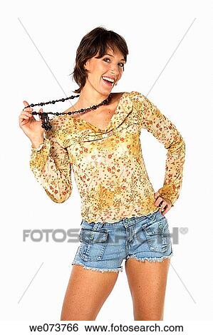 Young woman plays with a necklace in a studio setting View Large Photo Image Stock Photograph - Young woman plays with a necklace in a studio setting. Fotosearch