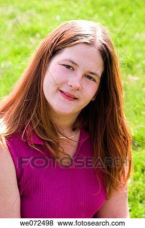 Young woman posing for a photo at a park. View Large Photo Image Stock Photo - Young woman posing for a photo at a park.. Fotosearch