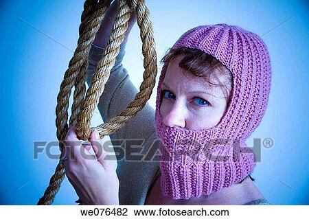 Young woman, wearing a knitted hood and holding a thick rope, posing. View Large Photo Image Stock Image - Young woman, wearing a knitted hood and holding a thick rope, posing.. Fotosearch