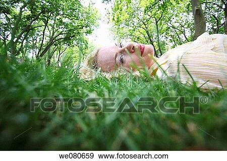 30 year old woman on grass View Large Photo Image Stock Photo - 30 year old woman on grass. Fotosearch