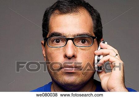 40 year old latin man speaking on a cell phone View Large Photo Image Stock Photo - 40 year old latin man speaking on a cell phone. Fotosearch