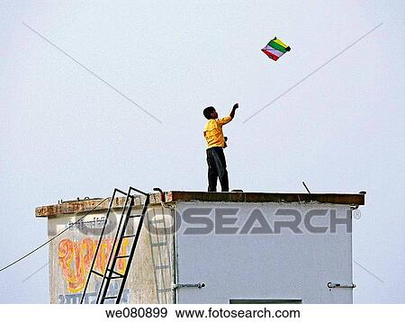 A boy playing with a kite, kite in flight Pune, Maharashtra, India View Large Photo Image Stock Photo - A boy playing with a kite, kite in flight Pune, Maharashtra, India. Fotosearch