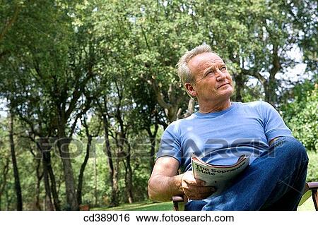 Stock Photograph - absent-mindedness, calm, baby boomer, absorbed, Absent-minded. Fotosearch