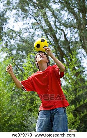 Stock Photo - action, boy, ball, balance, ability. Fotosearch