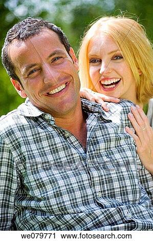 Stock Image - amusement, bond, blond, black hair, affection. Fotosearch