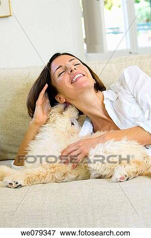animal, caress, brunette, at-home, amusement View Large Photo Image Stock Photo - animal, caress, brunette, at-home, amusement. Fotosearch
