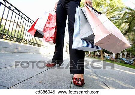 Stock Photography - anonymous, carrying, carry, bag, addiction. Fotosearch