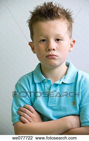 Stock Image - Arms crossed, boy, Bad mood, arms folded, angry. Fotosearch