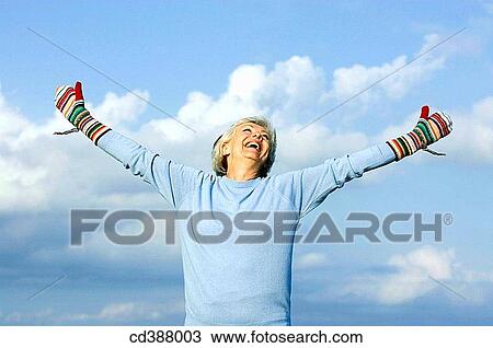 Arms open, carefree, blue, Arms raised, amusing View Large Photo Image Stock Image - Arms open, carefree, blue, Arms raised, amusing. Fotosearch