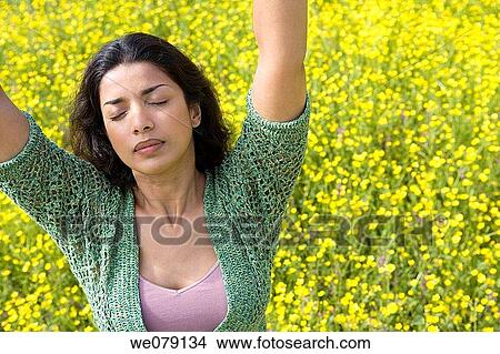 Asian, chilling out, Arms raised View Large Photo Image Picture - Asian, chilling out, Arms raised. Fotosearch
