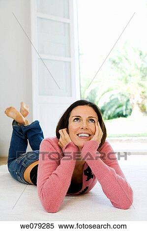 Stock Photography - at-home, brunette, barefoot, absorbed. Fotosearch
