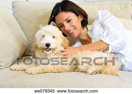 Stock Photography - at-home, caress, calm, brunette, animal. Fotosearch
