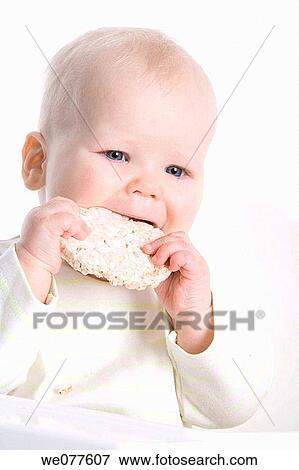 Stock Photo - baby, bite, biting, blond, blue eyes. Fotosearch