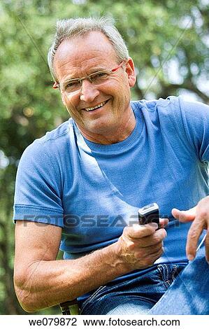 Stock Image - baby boomer, cell phone, communication. Fotosearch