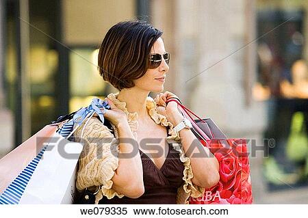 Stock Photography - bag, carrying, carry, brunette, addiction. Fotosearch