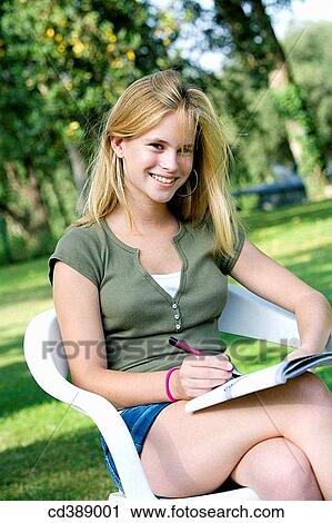 Stock Image - Ball-point pen, chair, contemporary, cross-legged. Fotosearch