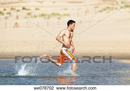 Stock Image - barefoot, beach, black hair, coast. Fotosearch