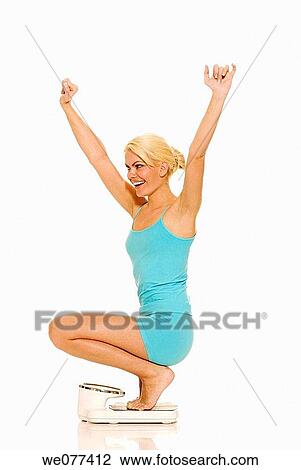 barefoot, blond, Bathroom scale, Arms raised View Large Photo Image Stock Image - barefoot, blond, Bathroom scale, Arms raised. Fotosearch