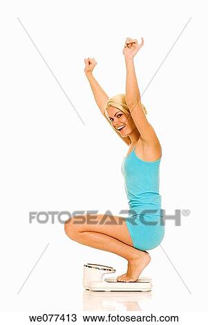 barefoot, blond, Bathroom scale, Arms raised View Large Photo Image Stock Image - barefoot, blond, Bathroom scale, Arms raised. Fotosearch