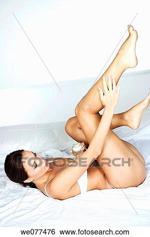 Stock Photograph - barefoot, brunette, Body care, beauty, apply. Fotosearch