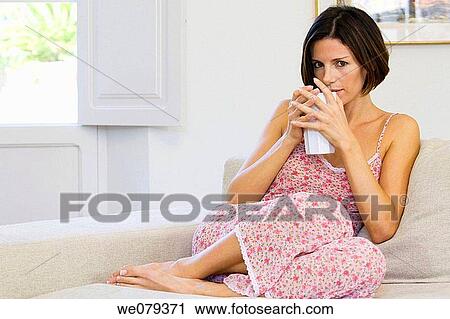 Stock Image - barefoot, calm, brunette, at-home. Fotosearch