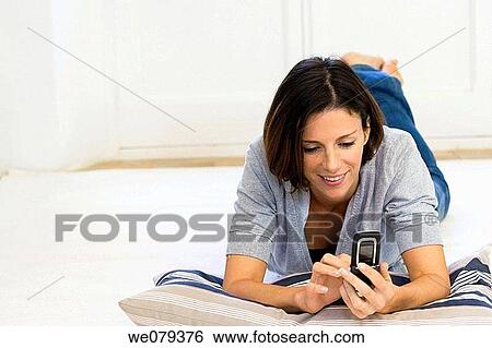 barefoot, cell phone, brunette, at-home View Large Photo Image Stock Photograph - barefoot, cell phone, brunette, at-home. Fotosearch