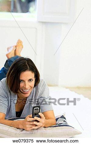 barefoot, cell phone, brunette, at-home View Large Photo Image Stock Photography - barefoot, cell phone, brunette, at-home. Fotosearch