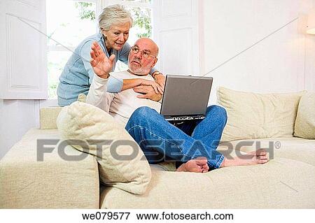 Stock Photo - barefoot, computer, at-home. Fotosearch