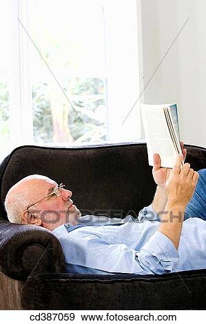 Stock Photo - beard, calm, book, at-home. Fotosearch