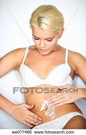Stock Photograph - beauty, Body care, blond, belly, apply. Fotosearch