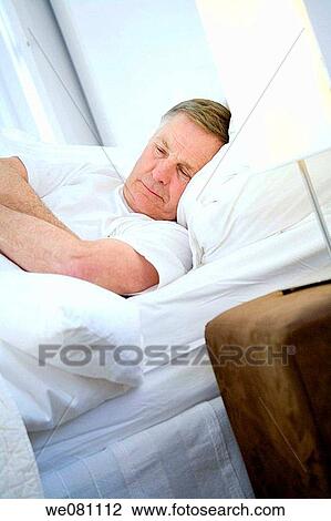 Stock Image - bed, chilling out, bedroom, at-home. Fotosearch