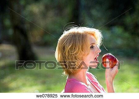 Stock Photography - bite, blond, biting, apple. Fotosearch