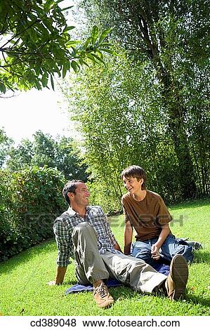 Stock Photo - black hair, chat, boy, amusement. Fotosearch