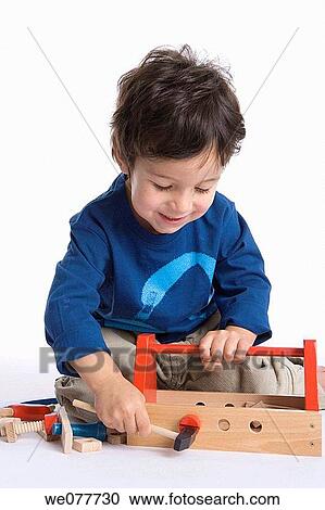 Stock Image - black hair, child, carpenter, boy, amusement. Fotosearch