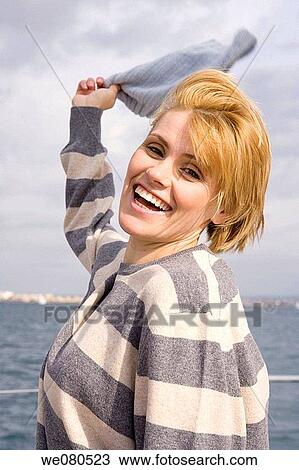 Stock Image - blond, cap, Arms raised. Fotosearch