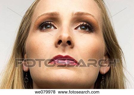 Blond woman posing in the Studio looking up View Large Photo Image Stock Photo - Blond woman posing in the Studio looking up. Fotosearch