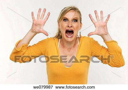 Blond woman screaming in the studio View Large Photo Image Stock Photo - Blond woman screaming in the studio. Fotosearch
