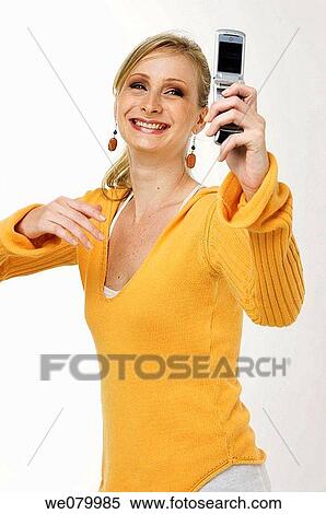 Blond woman, taking a picture of herself with a cell phone View Large Photo Image Stock Photography - Blond woman, taking a picture of herself with a cell phone. Fotosearch