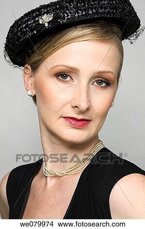 Blond woman with hat posing in the Studio View Large Photo Image Picture - Blond woman with hat posing in the Studio. Fotosearch