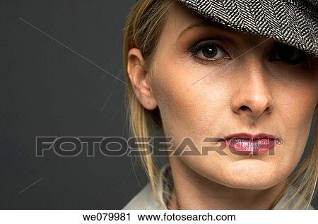 Blond woman with hat posing in the studio View Large Photo Image Stock Image - Blond woman with hat posing in the studio. Fotosearch